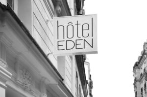 A welcoming atmosphere is created for guests in the Hôtel Eden Paris Porte de Versailles lobby by the elegant decor and gentle ambient lighting, which exude a subtle appeal.
