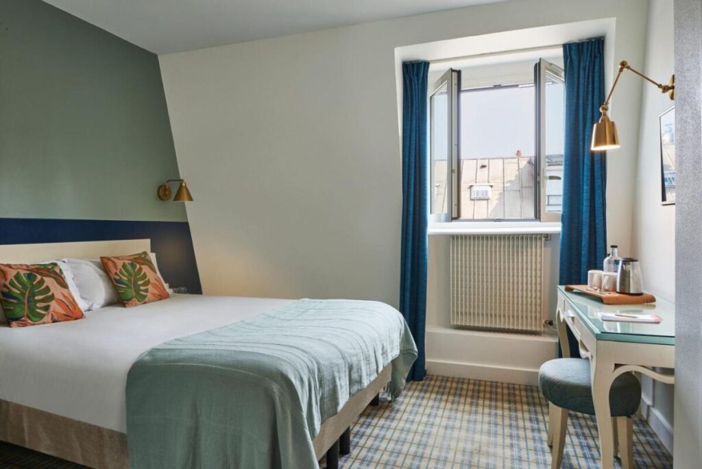 Bed and room interior in Hôtel Etoile Saint-Ferdinand by HappyCulture