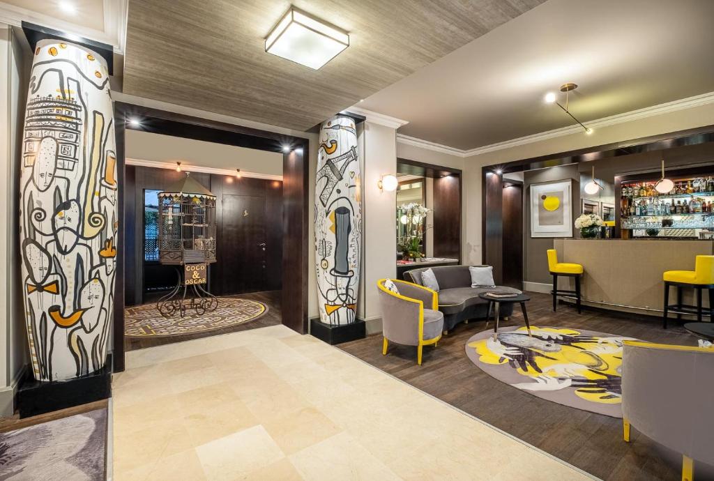 Indulge in the sophisticated lobby experience at Hôtel Le Marquis by Inwood Hotels, where modern design harmonizes with Parisian charm.