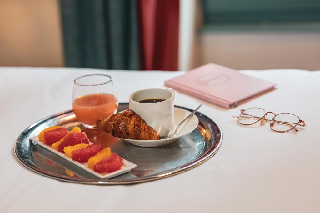 The elegant dining area at Hotel Le Petit Paris, characterized by chic decor, soft lighting, and tables set for a gourmet meal.