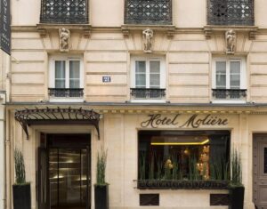 The classic facade of Hotel Moliere in Paris, showcasing its ornate architecture and elegant entrance.