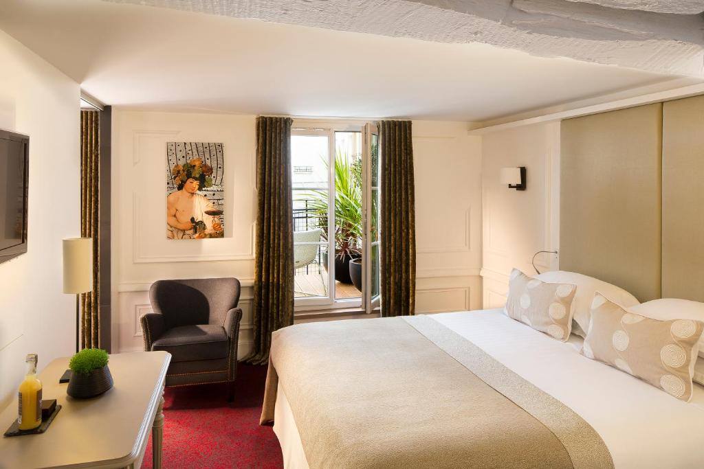 A well-appointed hotel room with a comfortable bed, tasteful decor, and a balcony opening to an urban view.