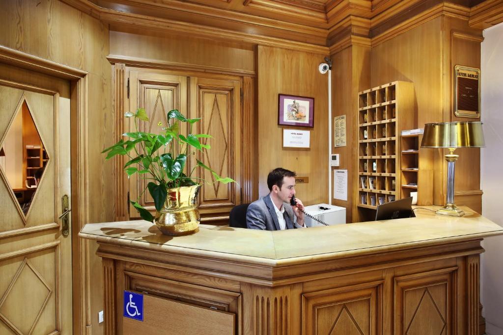 Hotel Murat Paris Reception: Step into a world of elegance and charm as you enter our welcoming reception area at Hotel Murat Paris.