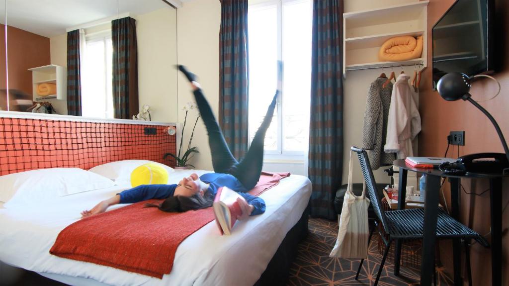 Rooms at Hotel Olympic Paris Boulogne by Patrick Hayat are designed with comfort and elegance, offering a serene retreat in the heart of the city.