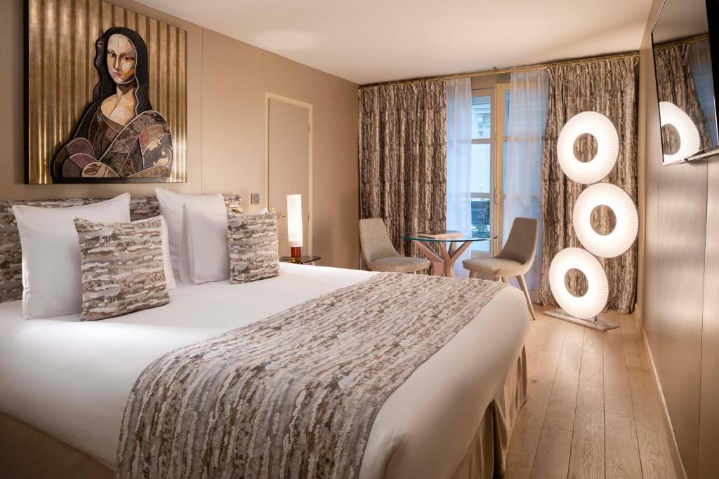 Interior of Hotel Pas De Calais showing a spacious bed and an artwork hanging above it.