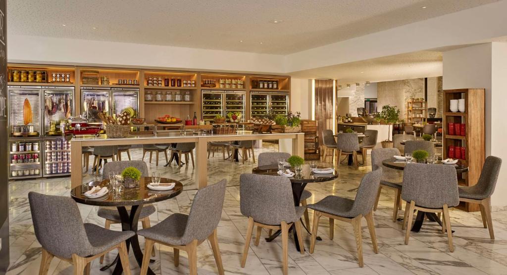 The rooms at Hyatt Regency Paris Etoile showcase contemporary elegance, featuring modern furnishings, plush bedding, and panoramic city views.
