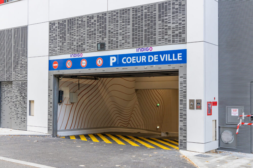 Entrance to an Indigo underground parking garage with wavy interior wall design