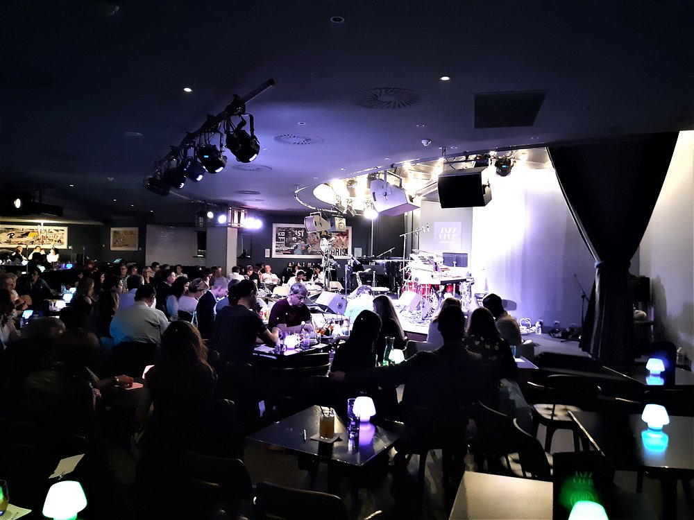 Interior of Jazz Club Etoile in Paris, showcasing a crowded room with guests seated at tables, enjoying live music