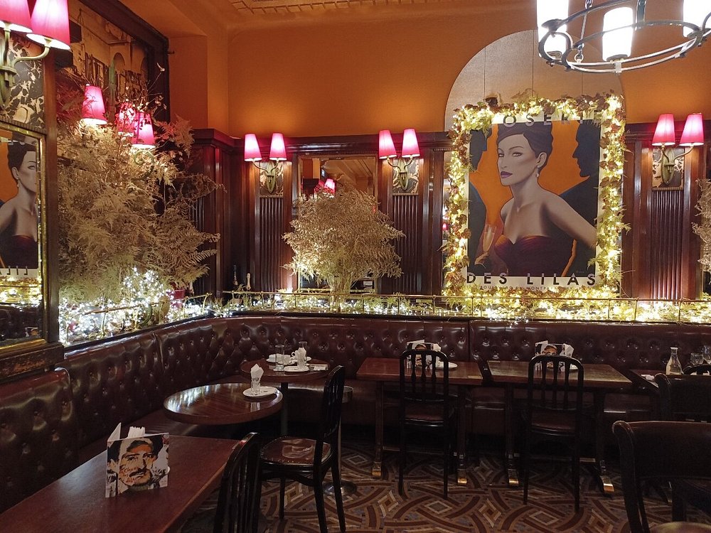 The dining room at the La Closerie des Lilas, Montparnasse, Paris, featuring elegant decor and tables set for guests in a historic setting.
