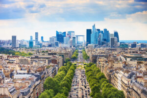 Aerial view of La Defense business district in Paris, showcasing modern skyscrapers along Grande Armee avenue.