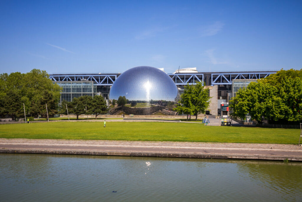 La Geode Omnimax Theatre, a spherical building in Parc de La Villette, Paris, reflects modern architecture and cinema