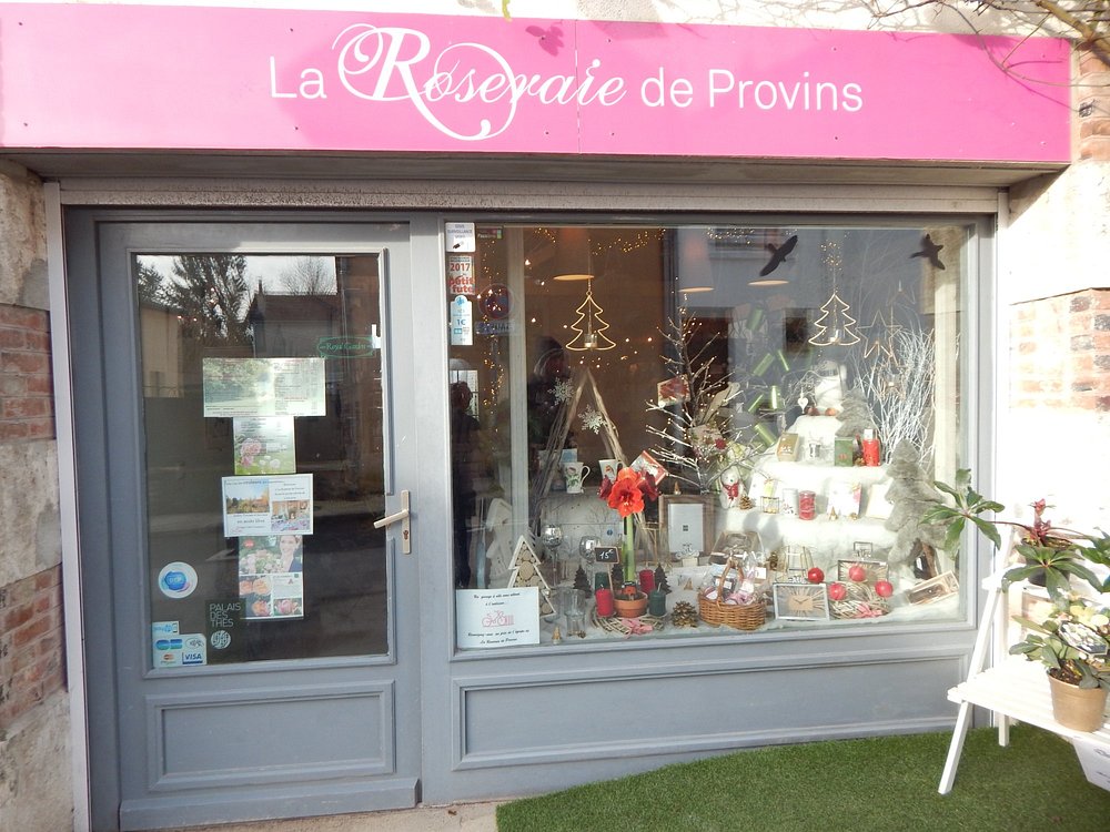 Storefront in Provins, France, featuring a sign that reads "La Rue Prune de Poirins" at La Roseraie de Provins.