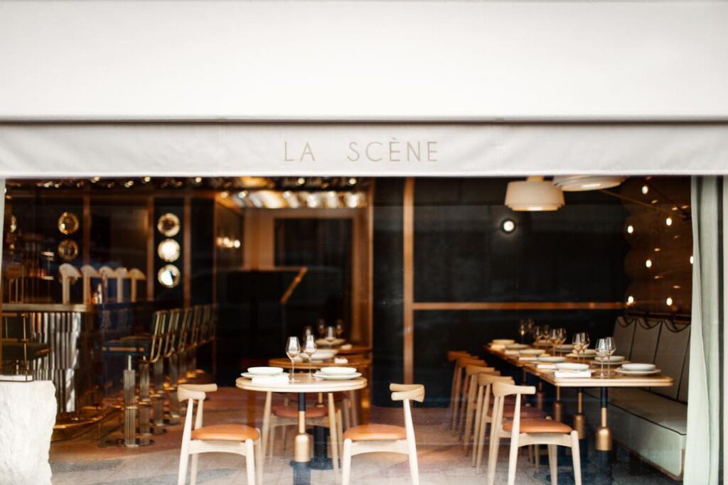 Front view of Restaurant La Scène in Paris, showcasing Stéphanie Le Quellec showing dining area with tables and chairs