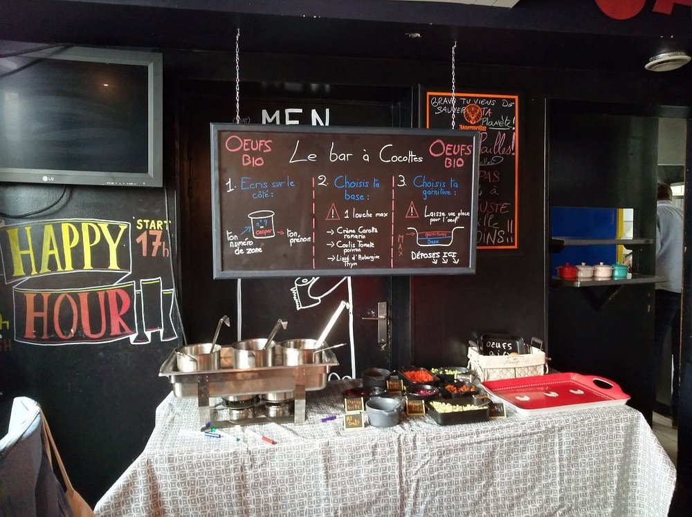 Blackboard menu at L'Adada Bar in Montparnasse, Paris, featuring chalk writing and daily specials.