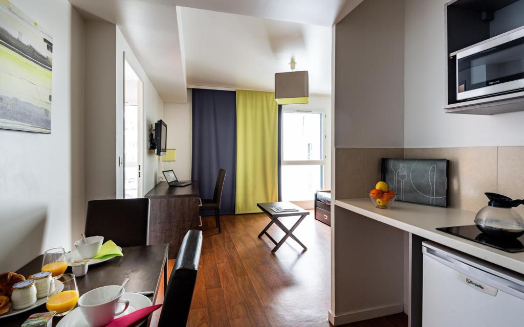 Exterior view of Lagrange Apart'Hôtel Paris-Boulogne, a modern and elegant accommodation option with stylish architecture and lush surroundings.