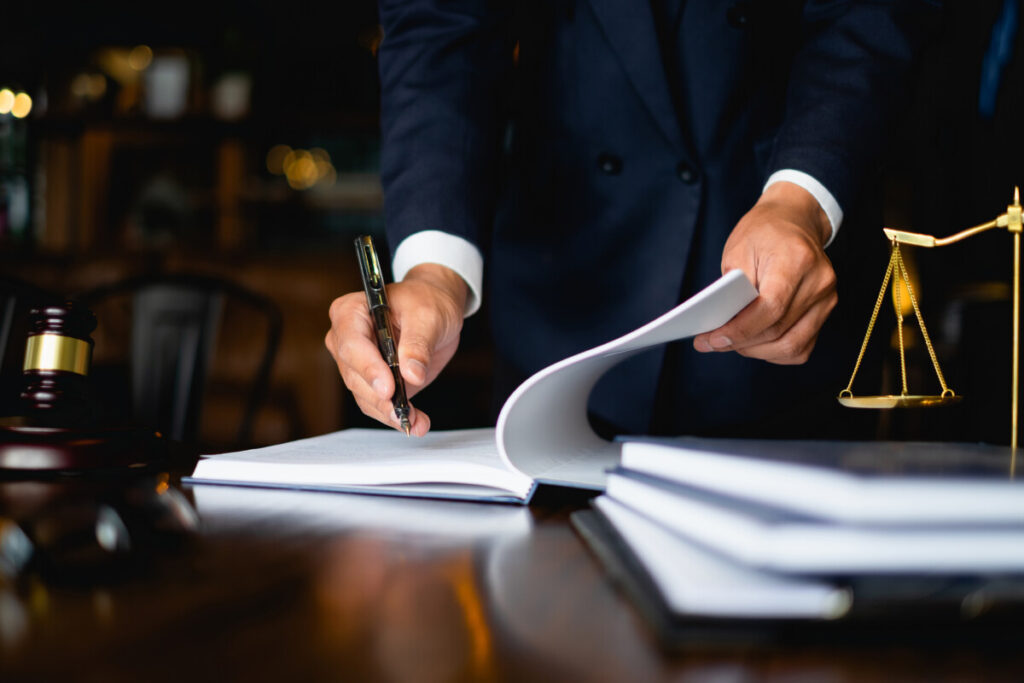 Lawyer signing and reviewing papers