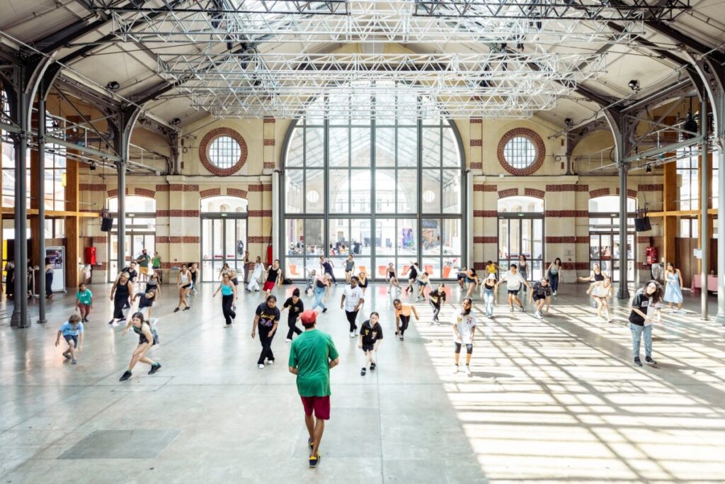 Le Centquatre Paris, a lively cultural hub, showcases art, shops, and dining options, attracting diverse crowds daily.