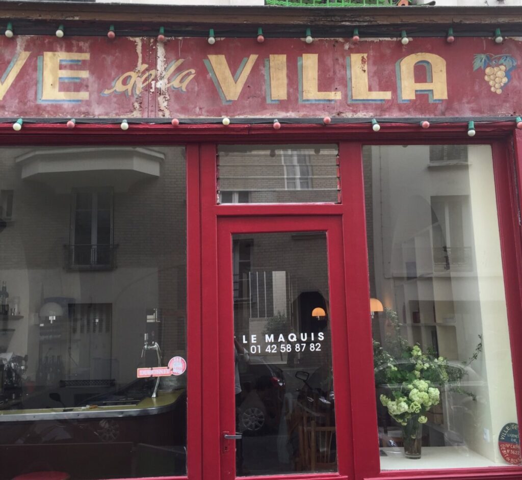 Exterior view of Le Maquis restaurant in Paris, showcasing its charming facade and inviting entrance.