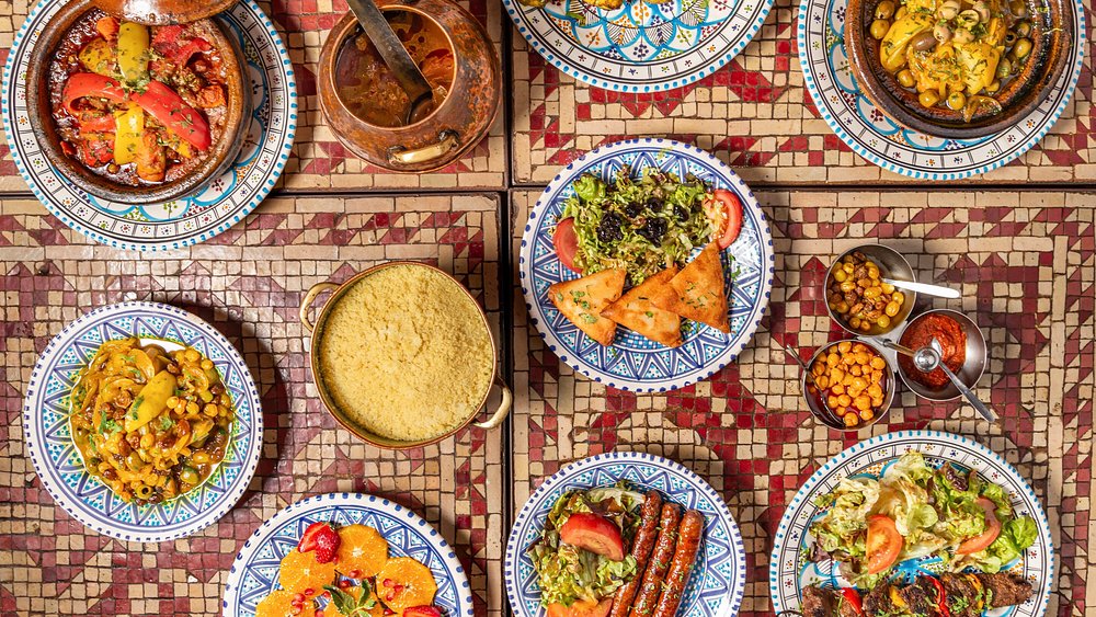 Vibrant table at Le Souk in Paris showcasing an array of plates filled with delicious food options.