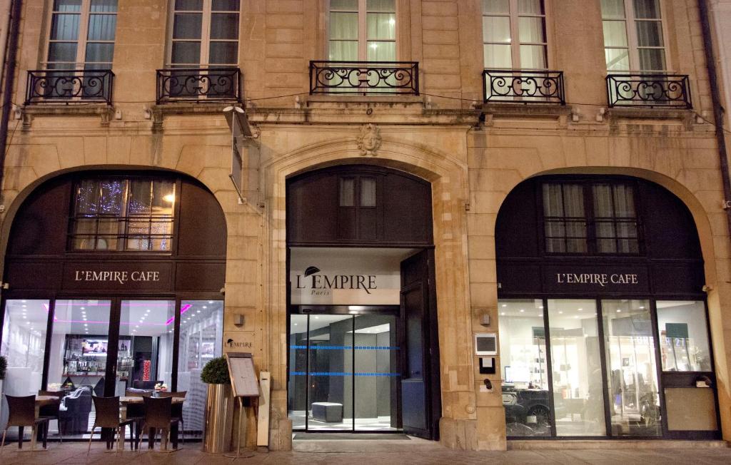 Exterior view of L'Empire Paris - Louvre, showcasing its elegant facade with classic architectural details.