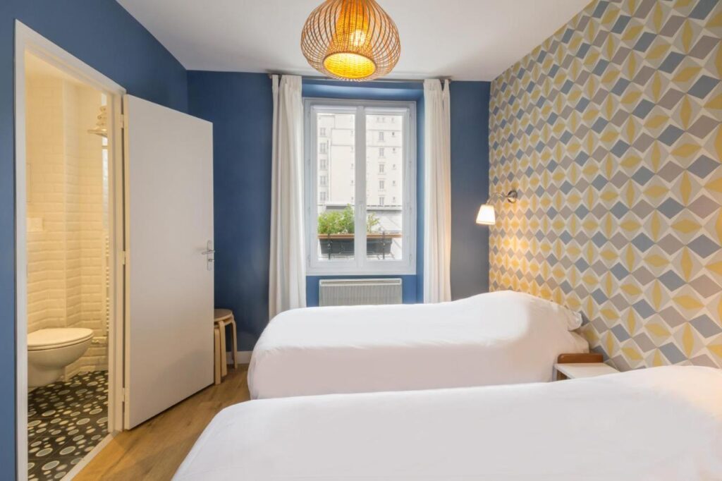 Two beds and room interior of Les Toits de Paris