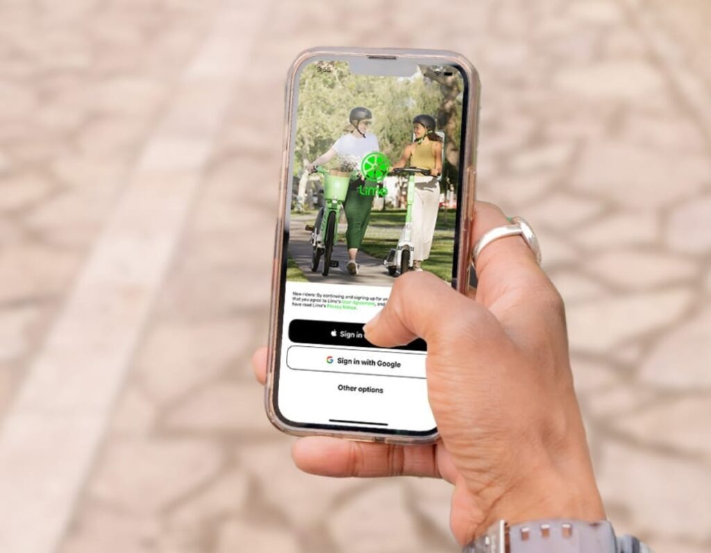 Hand presents a smartphone with a vibrant green screen showcasing the Lime Mobile App.