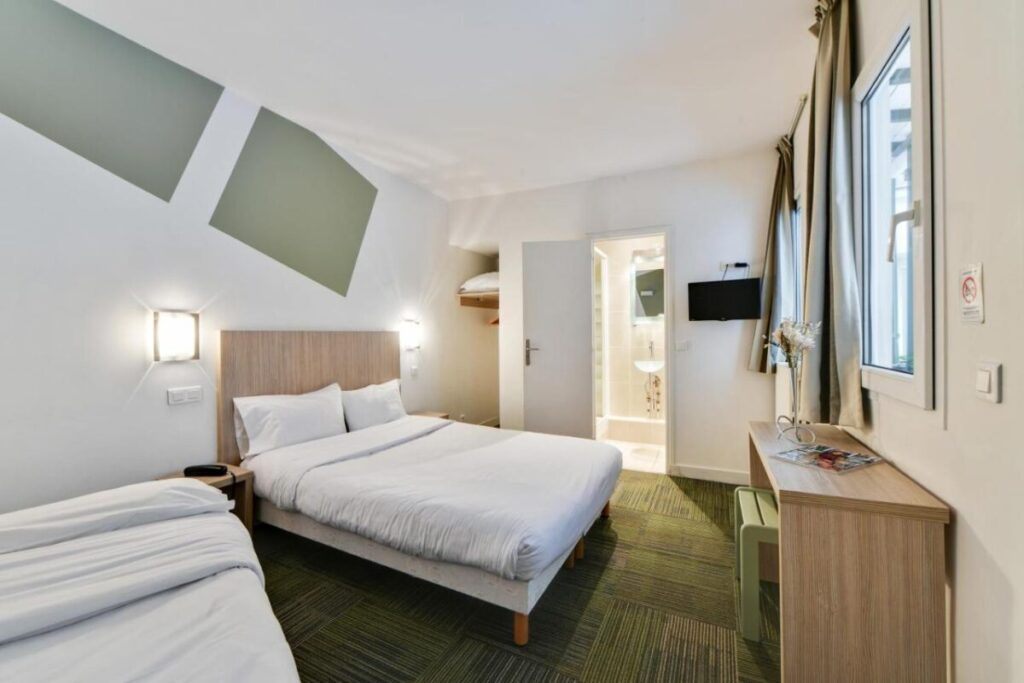 Bed and room interior in Louisa Hotel Paris