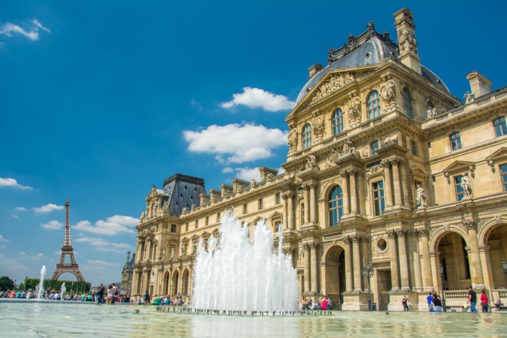 Tourists exploring the grounds of Louvre Museum in Paris, France