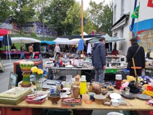 Marché aux Puces de Saint-Ouen in Paris, showcasing a vibrant flea market with tables overflowing with diverse items.