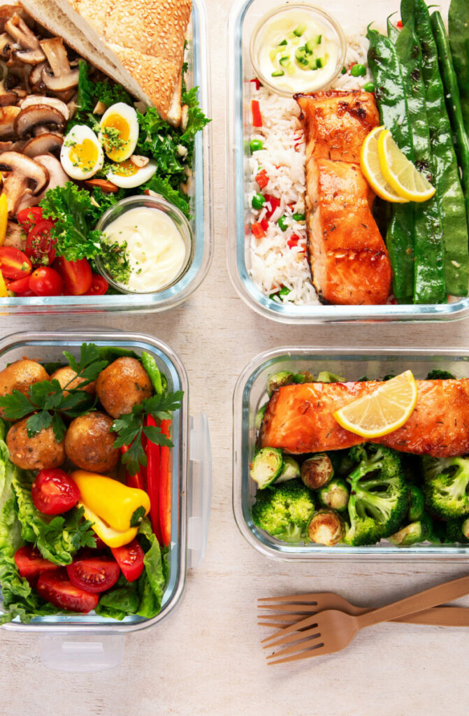 Colorful meal prep containers filled with high-protein foods like chicken, quinoa, and vegetables arranged neatly.