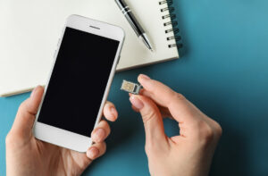 Woman putting a mobile sim card into a phone