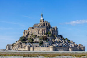 Panoramic view of Mont-Saint-Michel Abbey, showcasing its stunning architecture against the backdrop of Normandy's coastline.