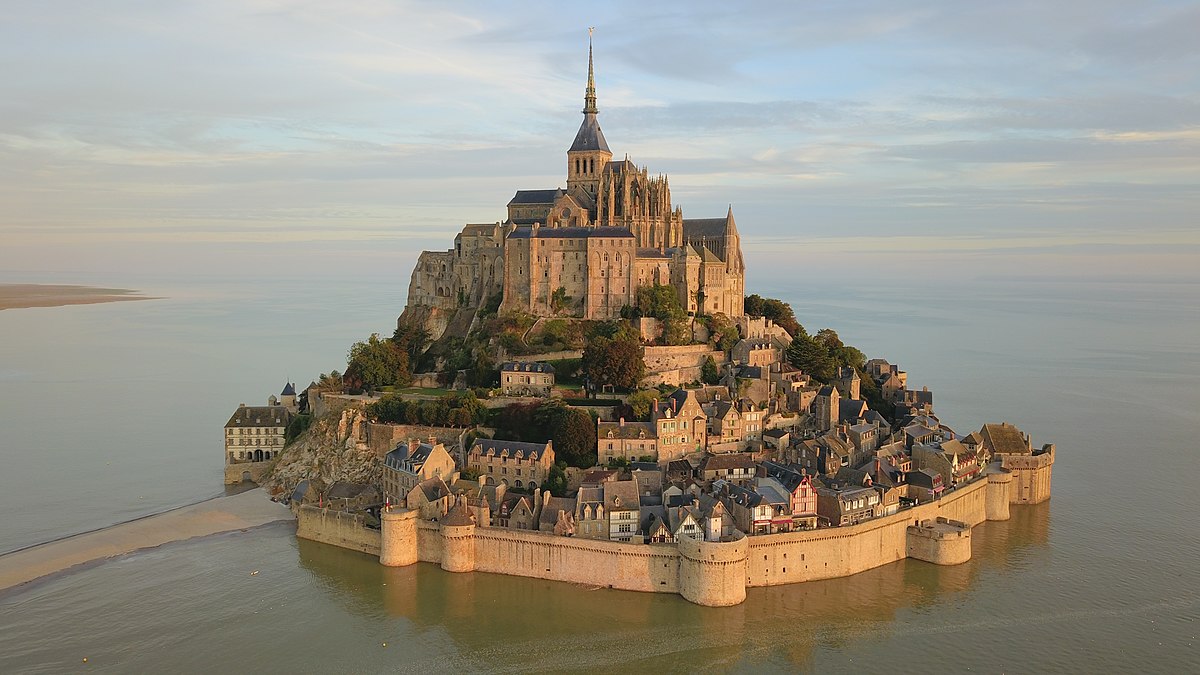 Mont-Saint-Michel seen from the sky at sunrise.