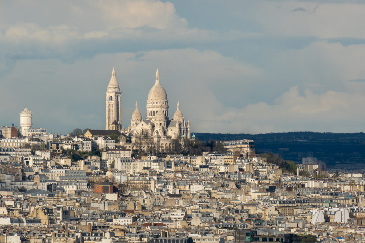 The Sacred Heart of Montmartre, a prominent basilica in Paris, perched on a hill with panoramic city views.