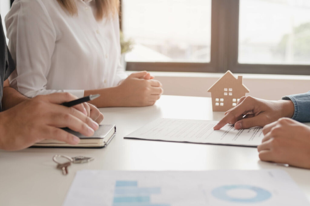 Mortgage Broker showing documents to a couple