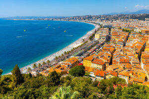 Nice panorama with Vieille Ville old town district, Promenade des Anglais boulevard and beach at French Riviera of Mediterranean Sea in France