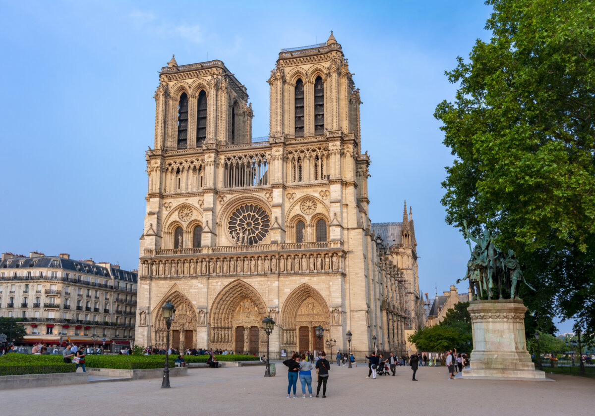 Notre Dame de Paris Cathedral, a historic Gothic structure, features intricate architecture and stunning stained glass windows.
