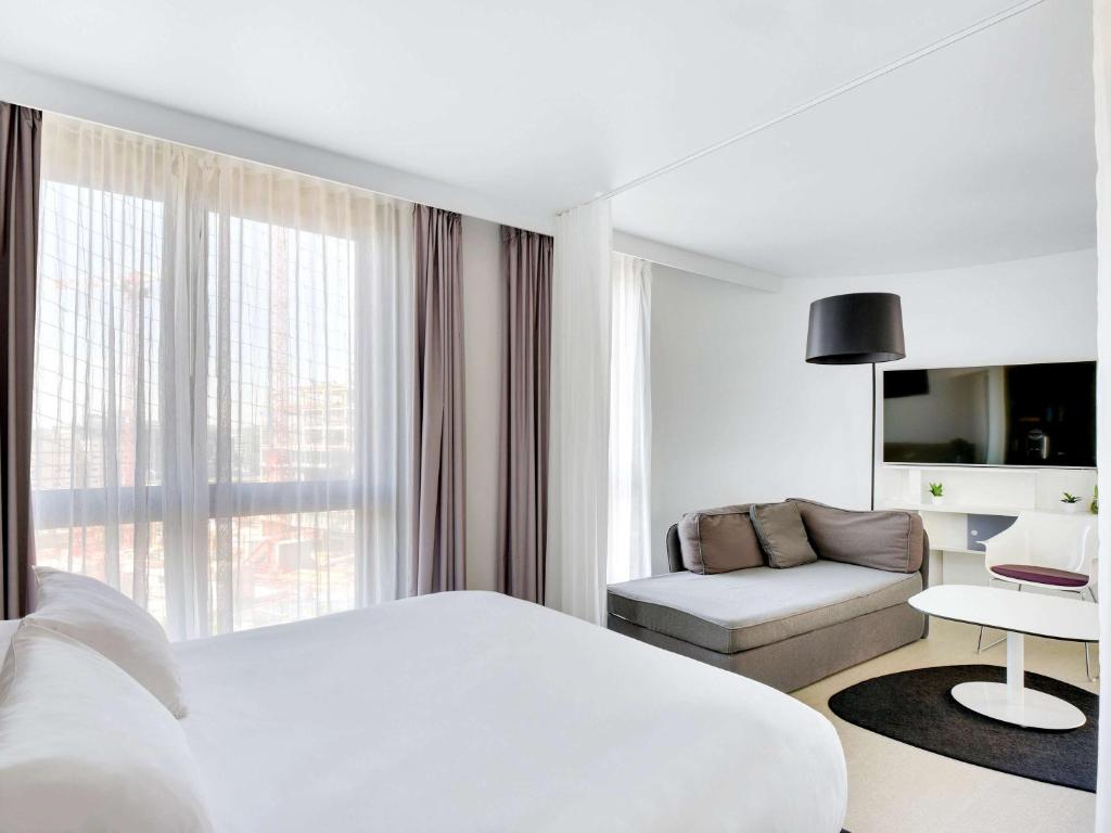Discover modern comfort at Novotel Suites Paris Issy les Moulineaux, where rooms feature contemporary design, functional amenities, and a cozy atmosphere.
