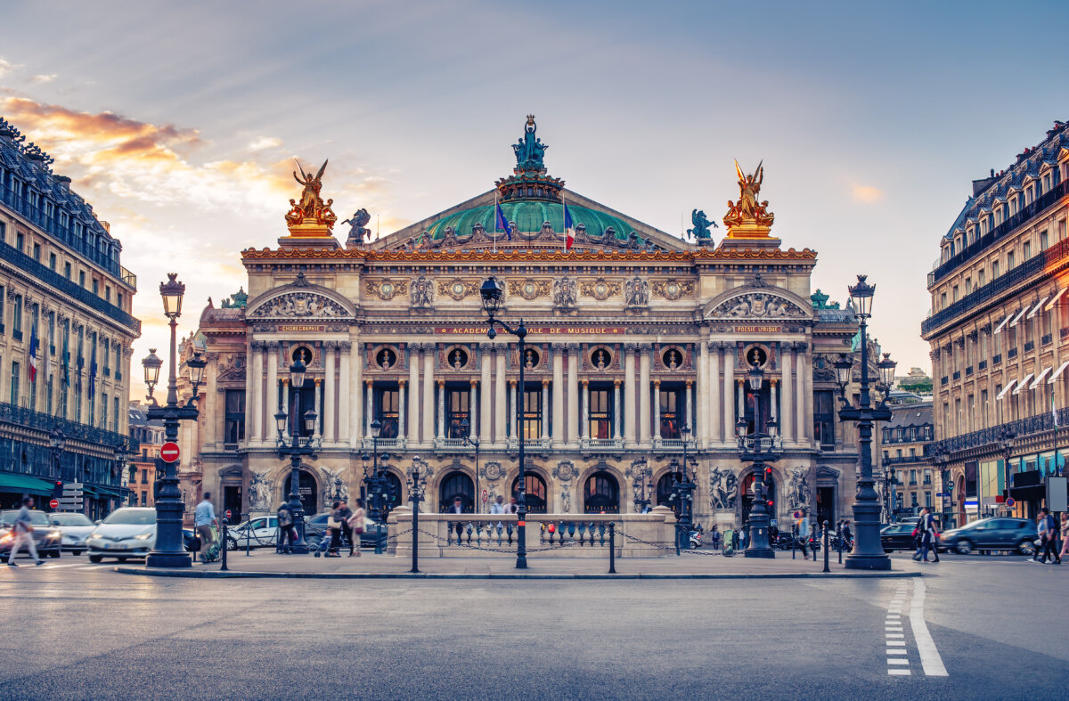 Scenic Paris skyline featuring the French Opera against a vibrant sunset, ideal for travel-themed backgrounds.