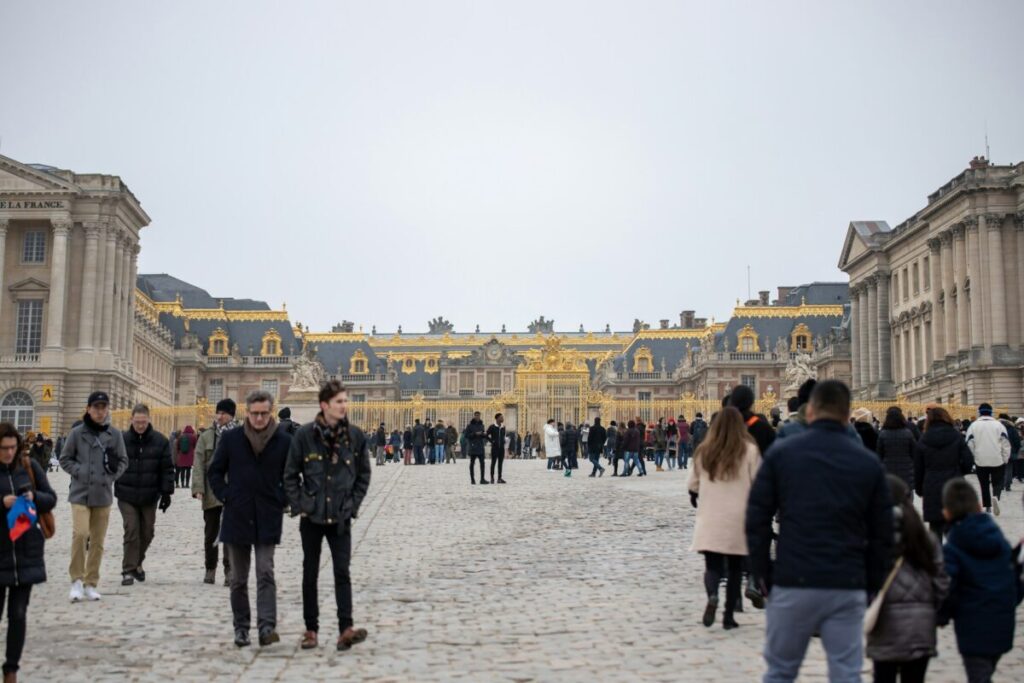 Tourists in front of Palace of Versailles, Versailles, France
