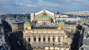 Aerial view of Palais Garnier, the iconic opera house in Paris, showcasing its grand exterior and ornate architecture.