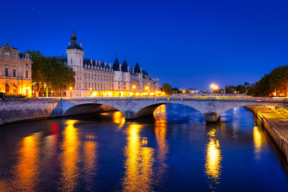The Conciergerie palace and prison by the Seine river at dawn, Paris. France