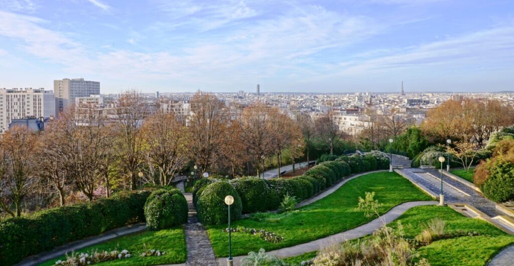 Panoramic view of the Paris skyline from Parc de Belleville, showcasing iconic landmarks in the 20th arrondissement.