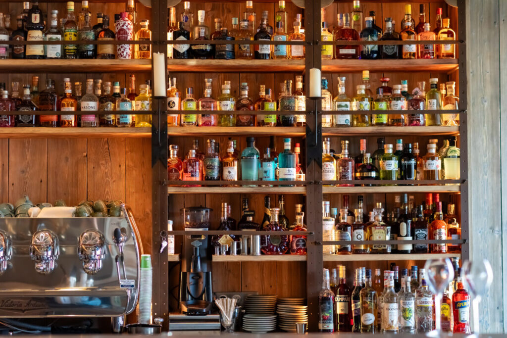Wine cabinet in a Paris bar displaying a variety of drinks, showcasing an elegant selection for patrons.