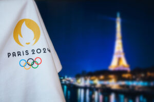 Summer olympic game Paris 2024 black background. Official logo of SOG 2024 in Paris on white blanket with dark City in night. Black edit space, sport event