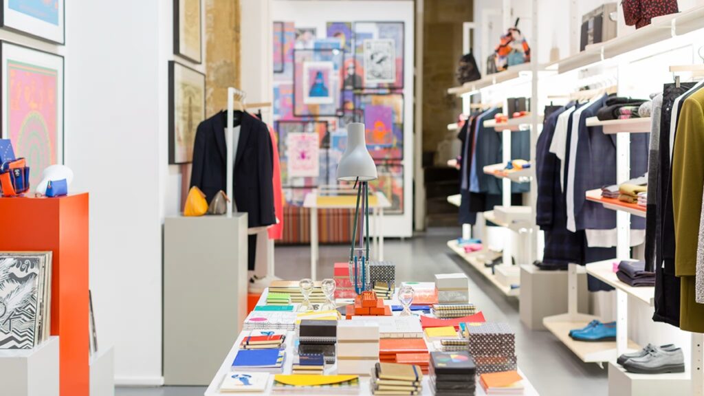 Interior view of Paul Smith Marais in Paris, featuring an array of fashionable clothing items on display.