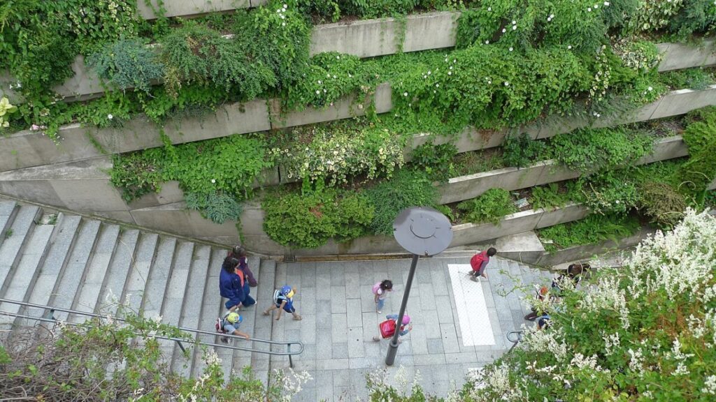People descending a staircase on the Promenade Plantée, captured from above in Paris, France.