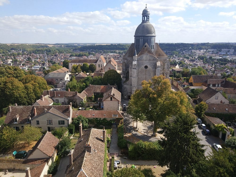 Panoramic view from a tower in Provins, France, showcasing the town's historic architecture and surrounding landscape.