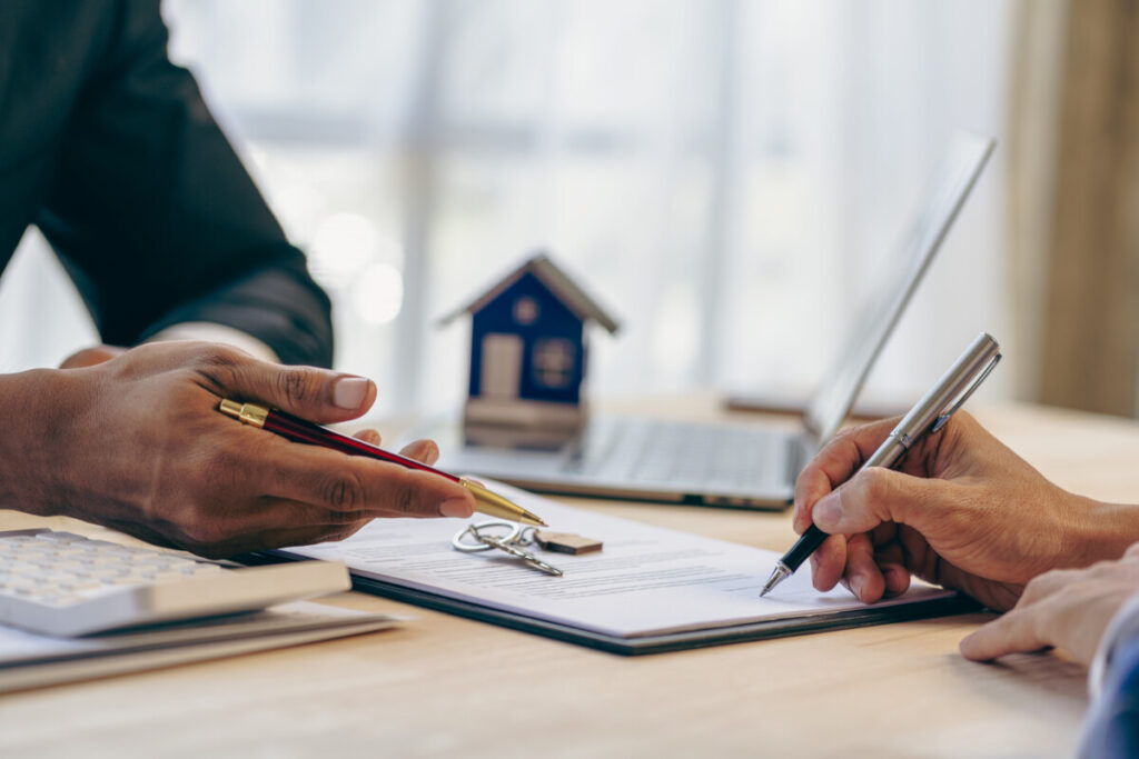 Real estate broker agent presenting documents a customer needed to sign