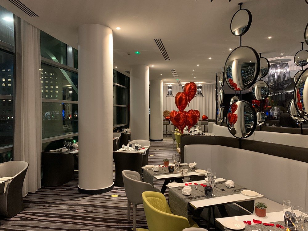 Parisian restaurant named Miroir featuring a large window and an expansive mirror, located in Ile-de-France.